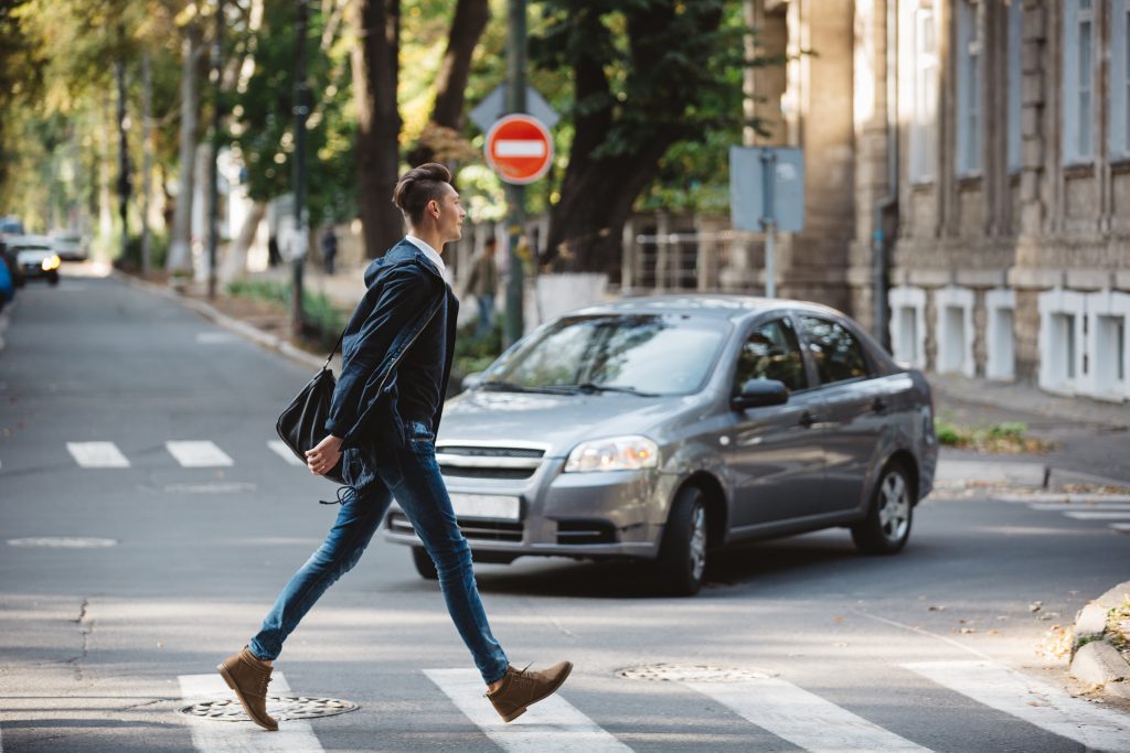 Young man cross the street